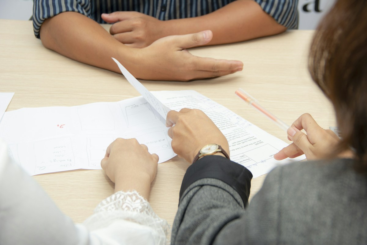 Two adults discussing a CV during an interview